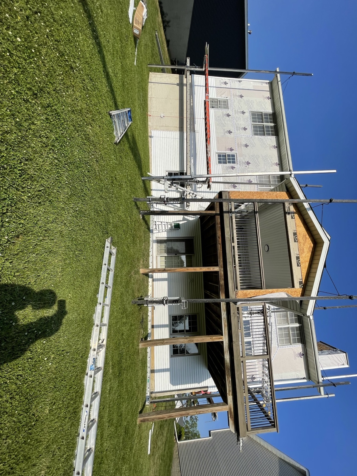 Residential roof replacement in progress in an Ankeny Iowa neighborhood by Black Ridge Contracting